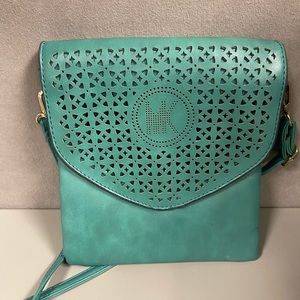 Cute laser cut unbranded crossbody bag. Turquoise